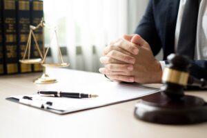 The lawyers sitting in their office is meticulously examining the judicial documents to gather crucial information and build a strong legal strategy for their client's case.